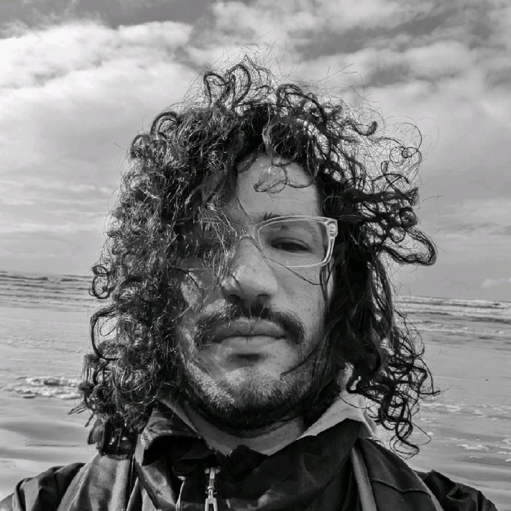 Hector, black and white, wind in the hair, ocean behind